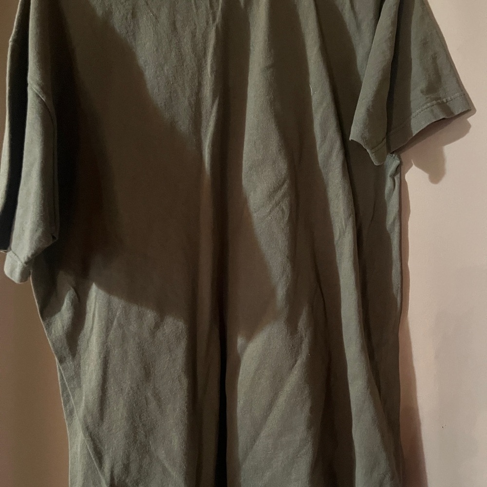 Green t-shirt with deer on front.